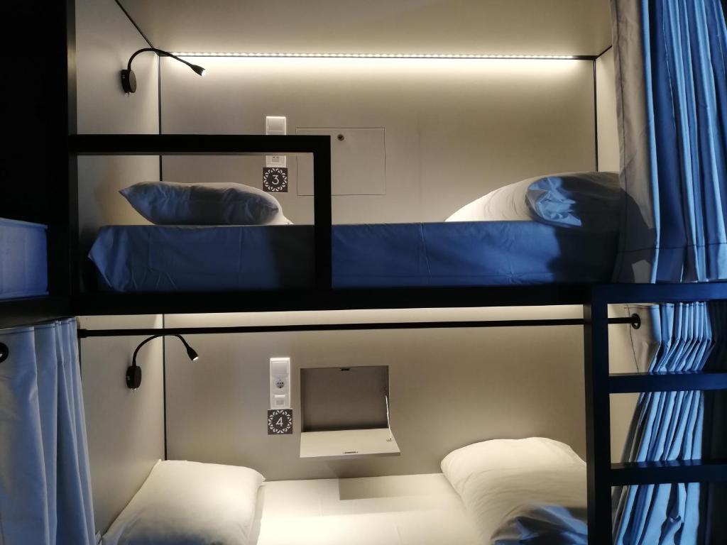 Uma cama ou camas num quarto em Villa Graça -Hostels and Apartments