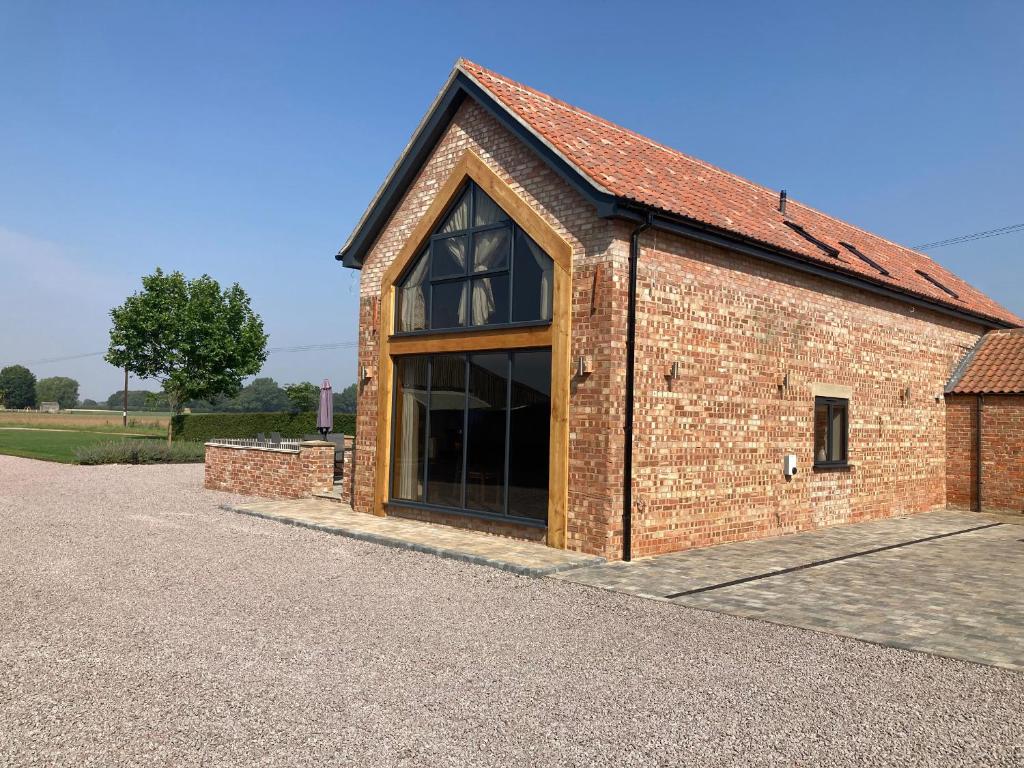 a large brick building with a large window at Old Willow Barn in Boston