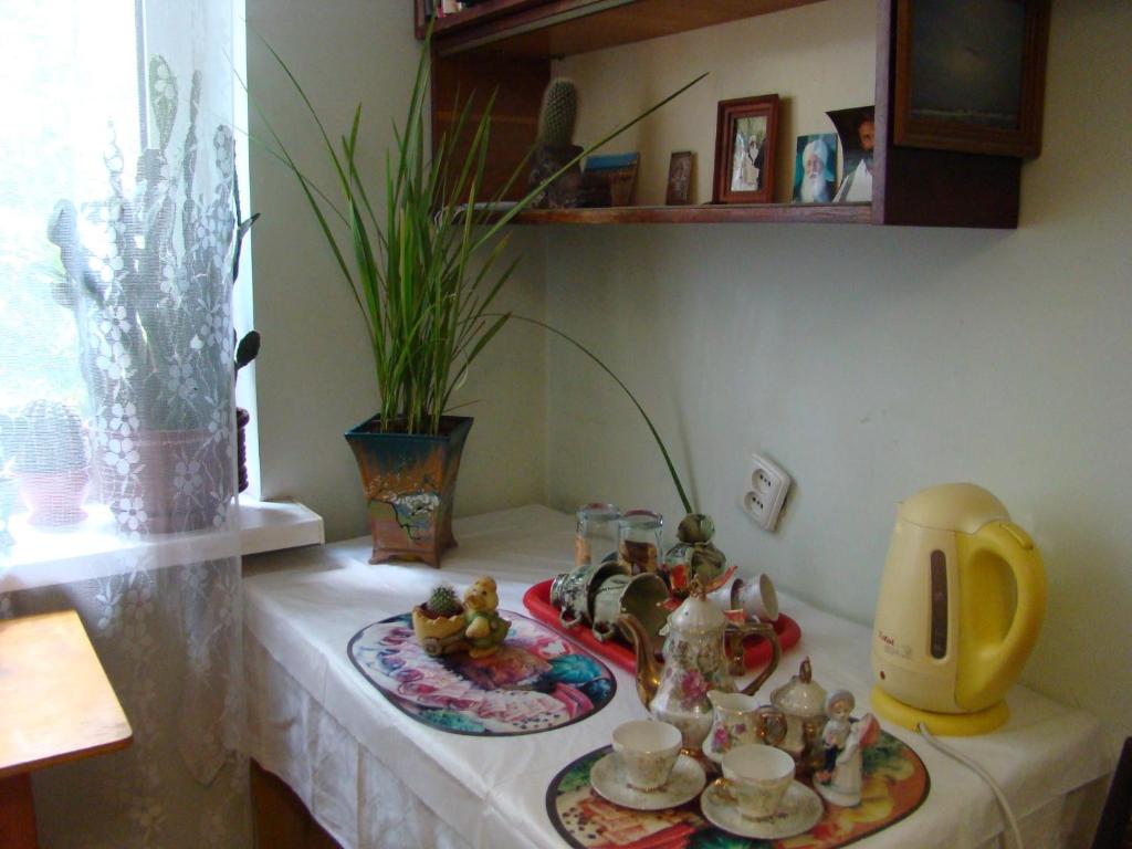a table with a tea set on top of it at Очень уютная, тихая, єко комната с видом на сад in Vinnytsya