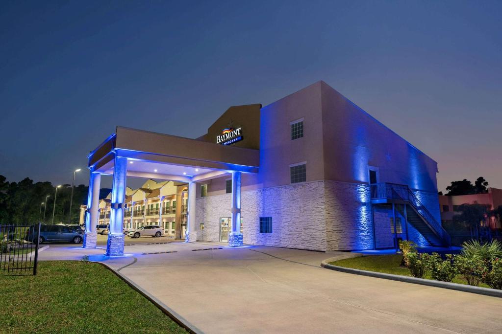 a building with blue lights on the side of it at Baymont by Wyndham Kingwood in Kingwood
