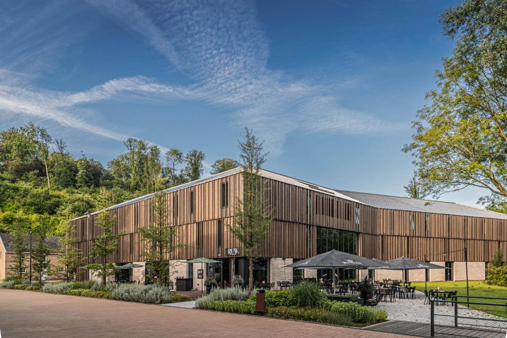 a rendering of a large wooden building at Hotel Valkenburg by Mercure - Next to Shimano Experience Center in Valkenburg