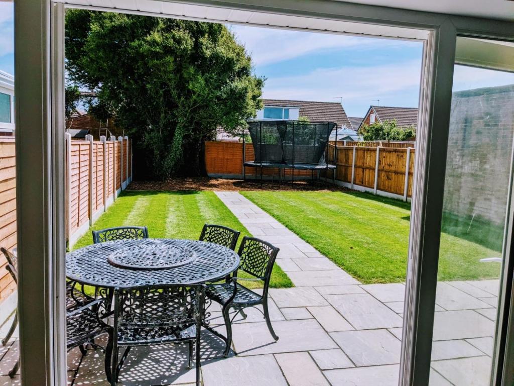 a patio with a table and chairs in a yard at Lovely 3-Bed House in Lytham Saint Annes in Saint Annes on the Sea