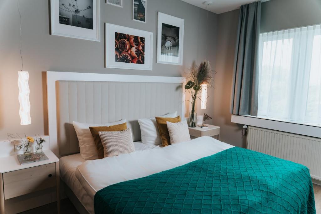 a bedroom with a bed with a green comforter at The Blasky in Frankfurt