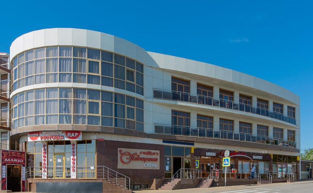 a building on the corner of a street at Panorama Hotel in Vityazevo