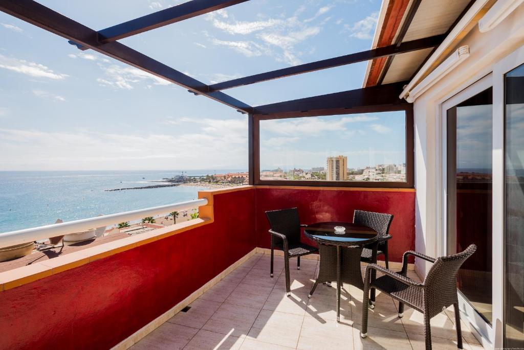 a balcony with a table and chairs and the ocean at Apartment Ceyla Beach View, Los Cristianos in Los Cristianos
