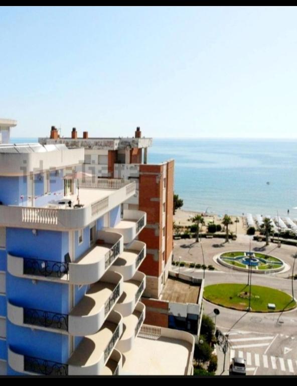 a view of a building with the ocean in the background at RICCIO BLU pochi passi dal mare in Alba Adriatica