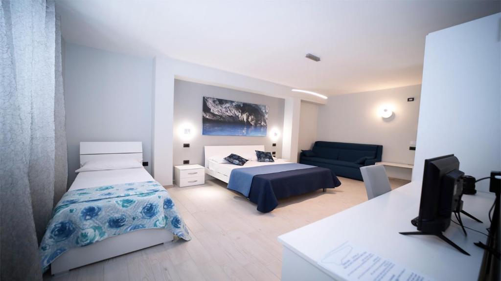 a bedroom with a bed and a couch at IsolaDino b&b sweet home in Praia a Mare