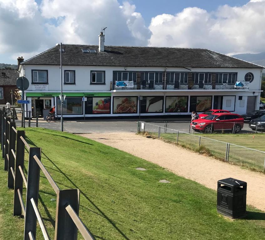 a building with a car parked in front of it at Beach Front Flat, Brodick in Brodick