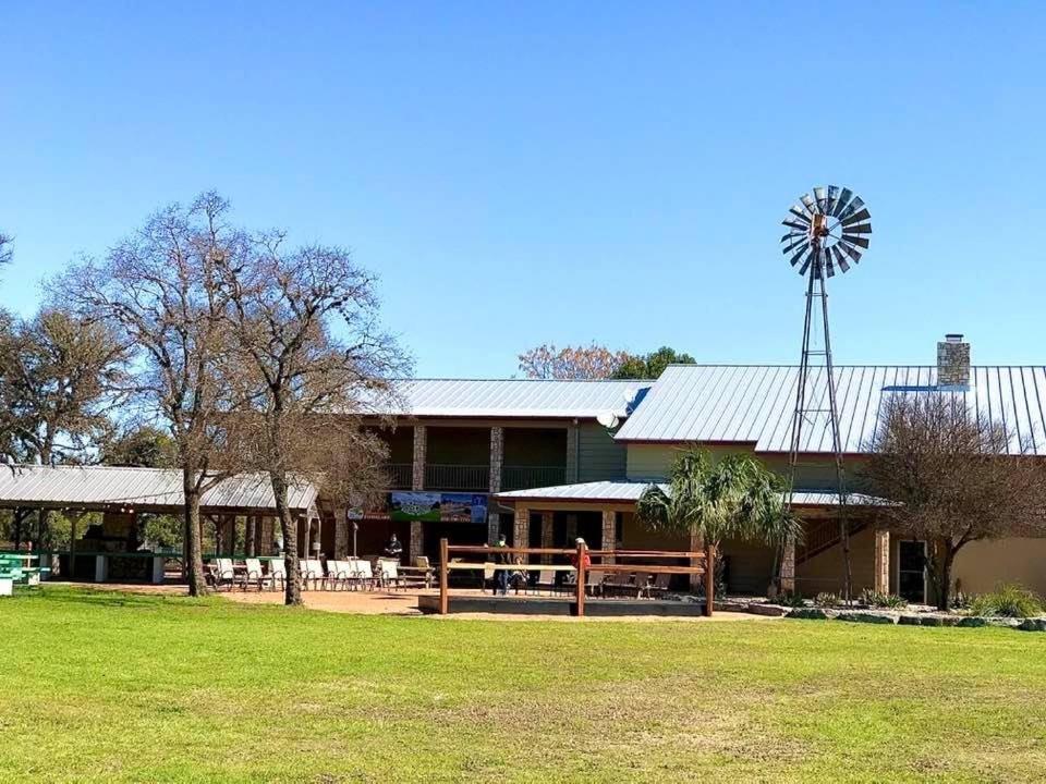 a building with a windmill on the side of it at Flying L Ranch Resort in Bandera