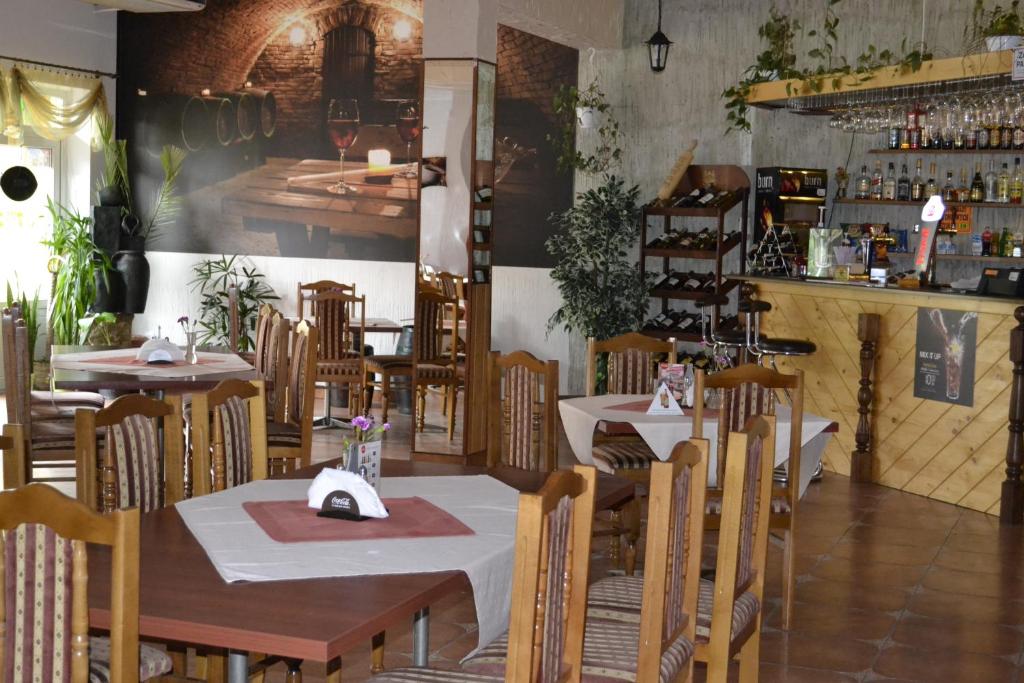 a restaurant with tables and chairs and a bar at Zajazd Maxim in Żywiec