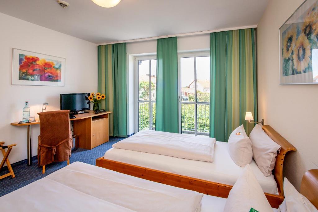 Postel nebo postele na pokoji v ubytování Arcus Hotel München Messe