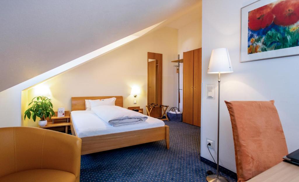 Postel nebo postele na pokoji v ubytování Arcus Hotel München Messe