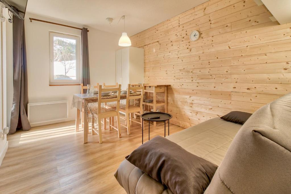 a living room with a couch and a dining room at Appartement confortable et lumineux a Genos in Génos