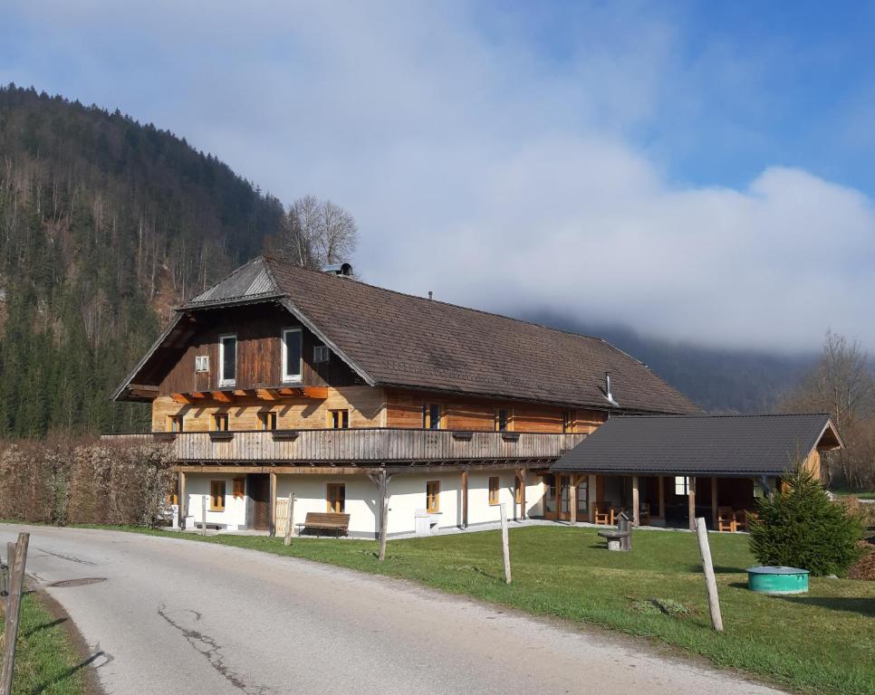 a large wooden house on the side of a road at Landhaus Algerhof in Abtenau