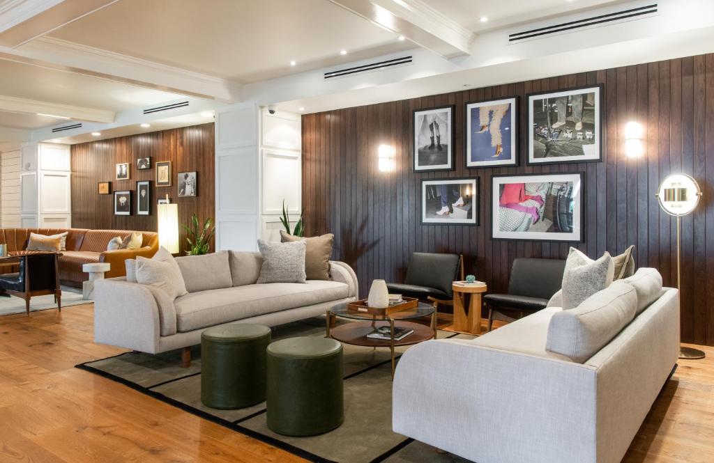 a living room with two couches and a table at Hutton Hotel in Nashville