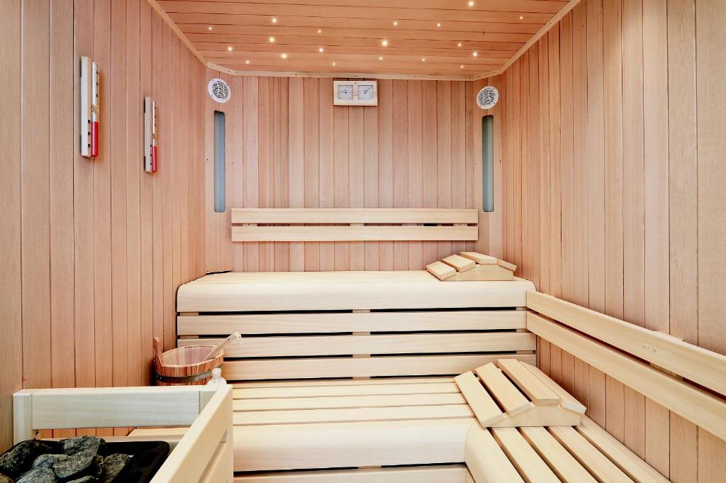 a sauna with two chairs in a wooden room at Grand Hotel & Riviera in Lido di Camaiore