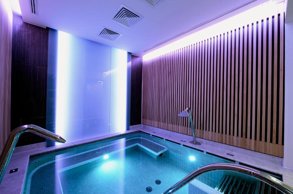 a bath tub with two faucets in a bathroom at Grand Hotel & Riviera in Lido di Camaiore