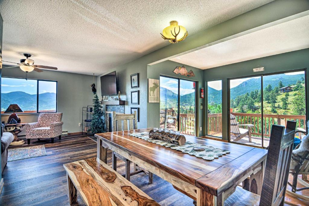 a dining room with a table and views of mountains at Idyllic Cabin with Grill and Panoramic Mtn Views! in Estes Park