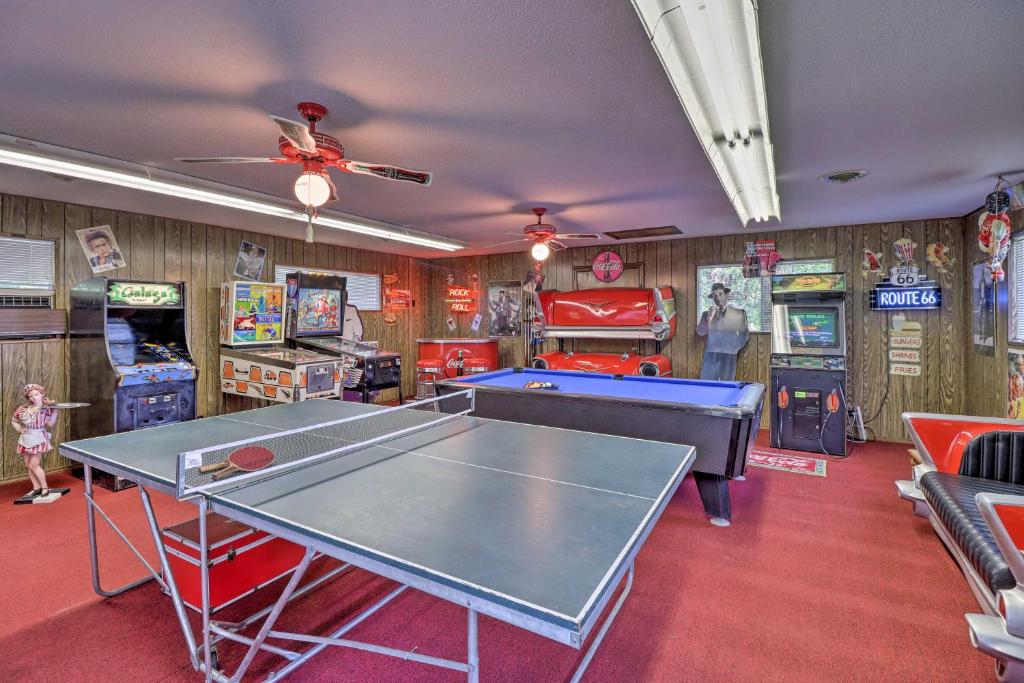 a room with a ping pong table and arcade games at Robinson Roost Retreat Less Than 2 Mi to Norfork Lake in Mountain Home