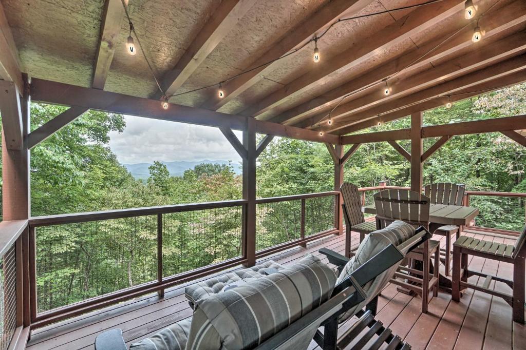 a screened in porch with a couch and a table at Yellow Mountain Blairsville Cabin with Scenic Deck in Hood