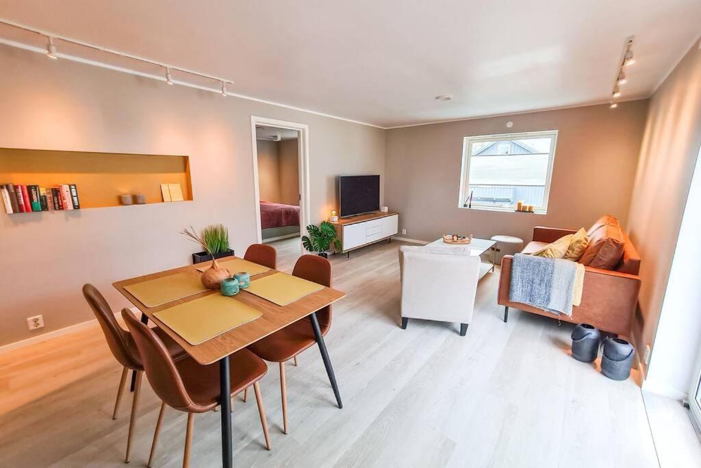 a living room with a table and a couch at Aurora Central Apartment, Bodø in Bodø