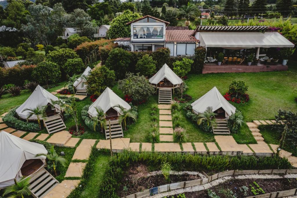 an aerial view of a house with tents in the yard at TEVA Glamping & Retreat in Rionegro