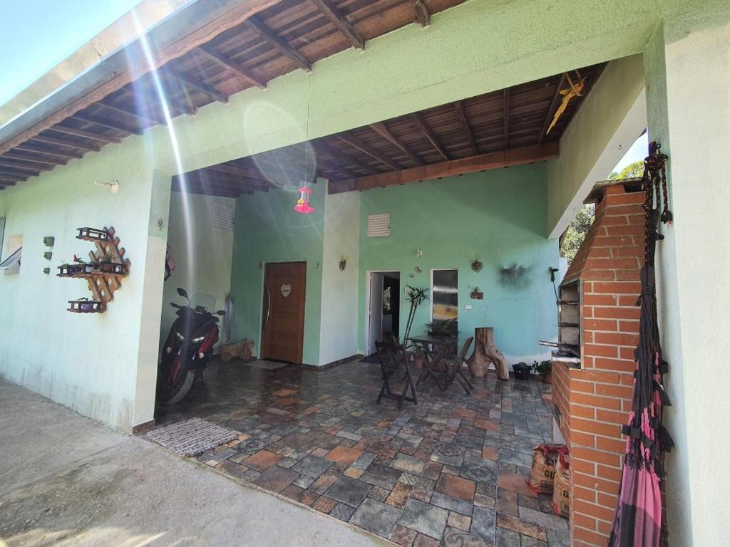 an open patio with motorcycles parked in a house at Chácara Cantinho da Paz in Ibiúna