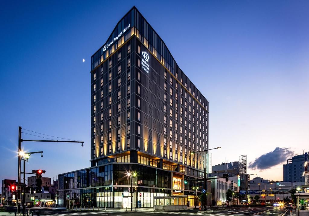 un grand bâtiment avec un panneau sur son côté dans l'établissement Daiwa Roynet Hotel Yamagata Ekimae, à Yamagata