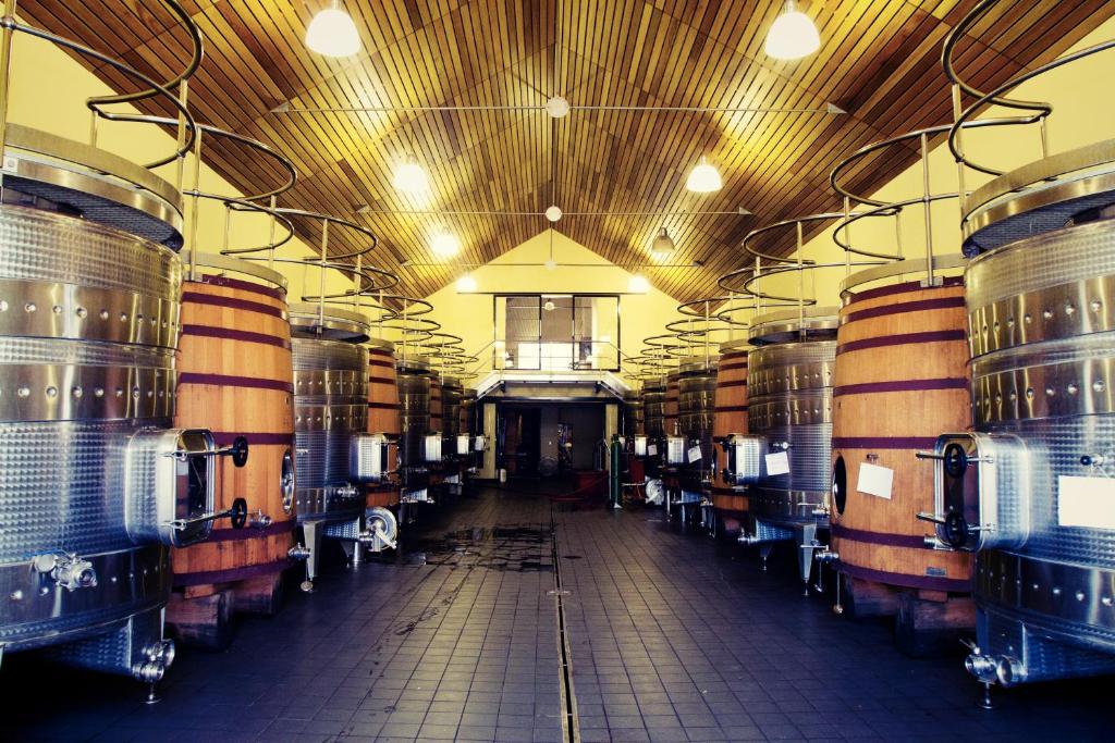 a large room with a bunch of wine barrels at Marianne Wine Estate in Stellenbosch