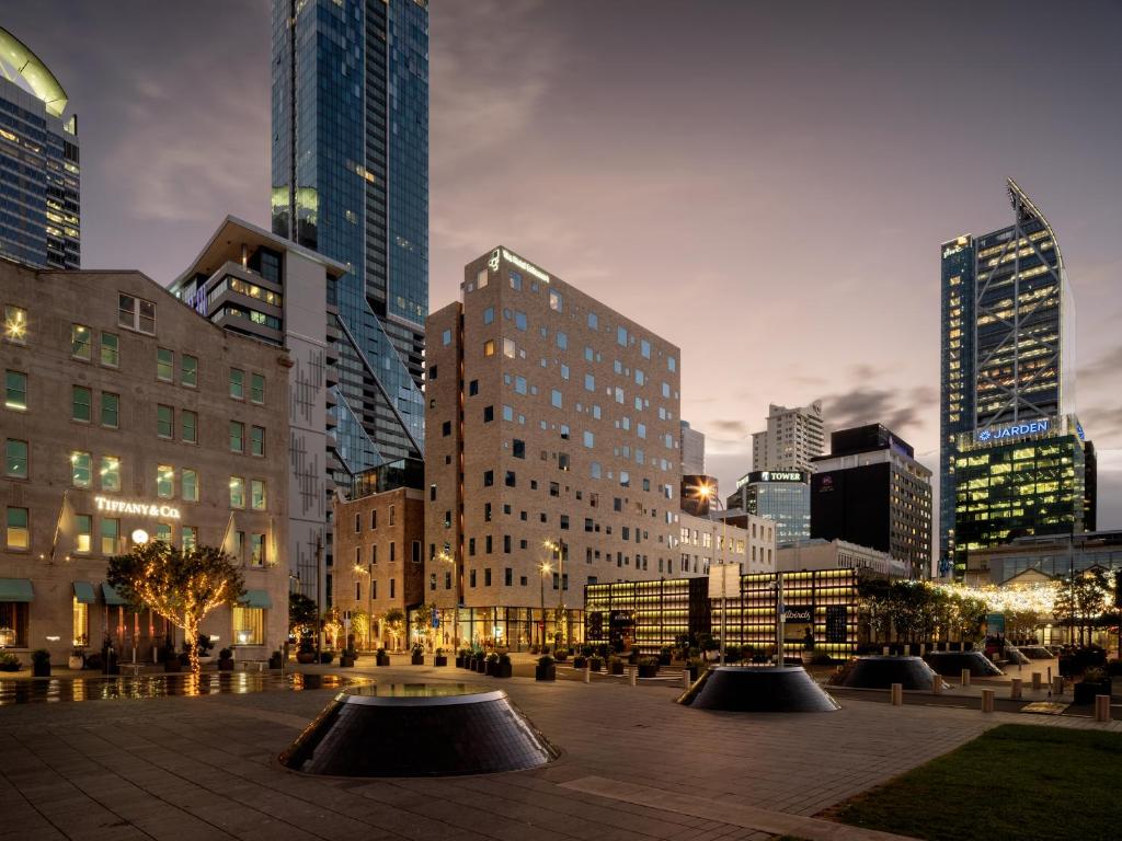 a city skyline with tall buildings in a city at The Hotel Britomart in Auckland