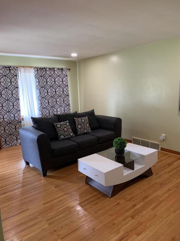 a living room with a couch and a coffee table at Niagara Falls Private Brick Vacation Home in Niagara Falls