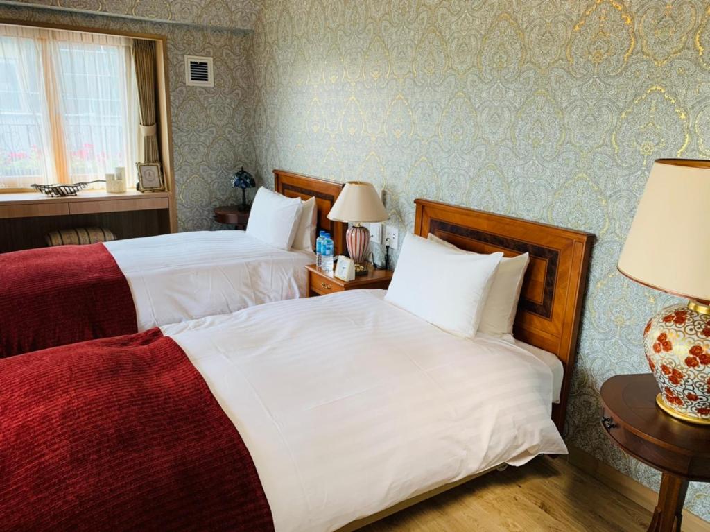 Postel nebo postele na pokoji v ubytování Auberge フレンチの森