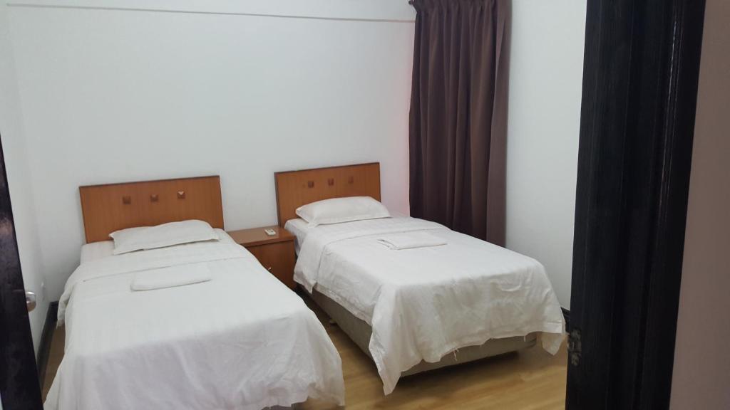 Voodi või voodid majutusasutuse Marina Court KK City Homestay toas