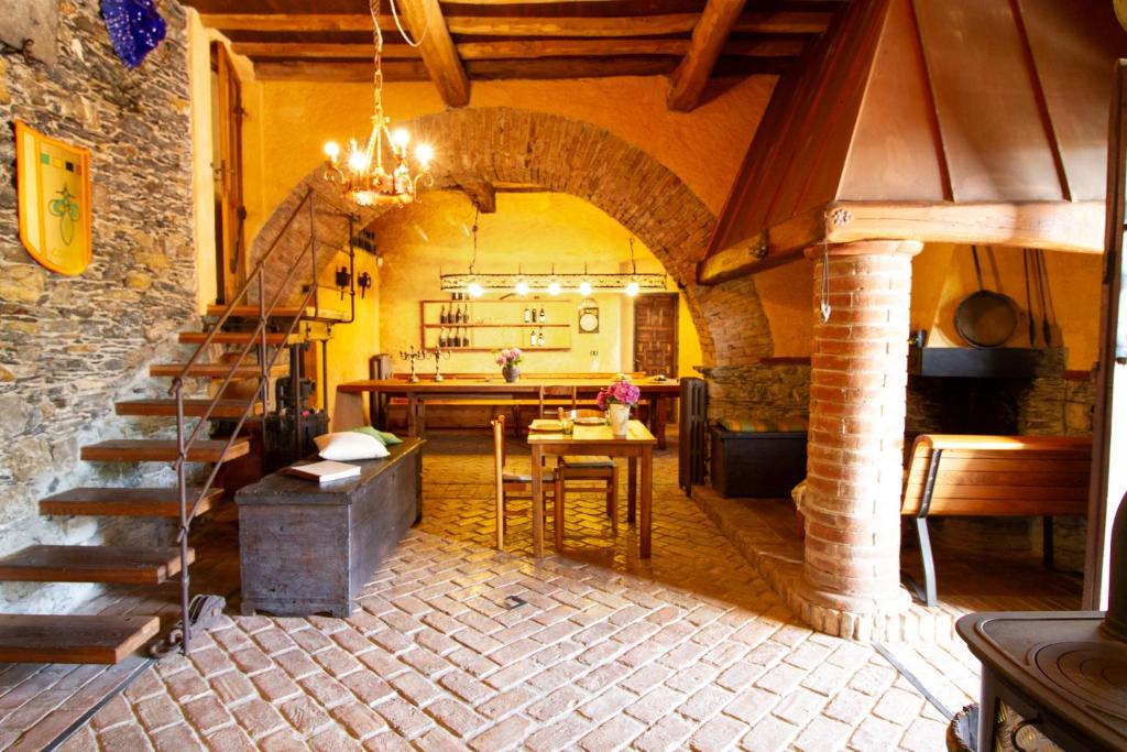 a kitchen and dining room with a staircase in a house at Rivarola al Tempo Dei Castelli in Carasco