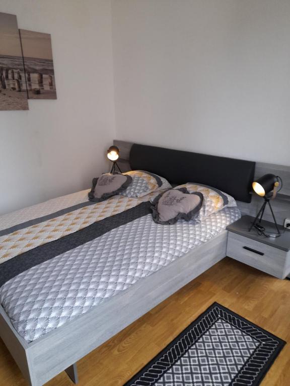 a bedroom with a bed with two bags on it at Le Samwest in Arromanches-les-Bains
