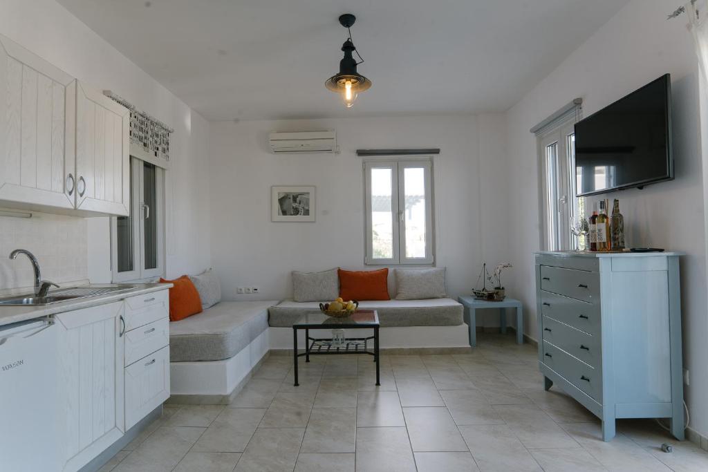 a living room with a couch and a table at Indigo Studios in Livadi
