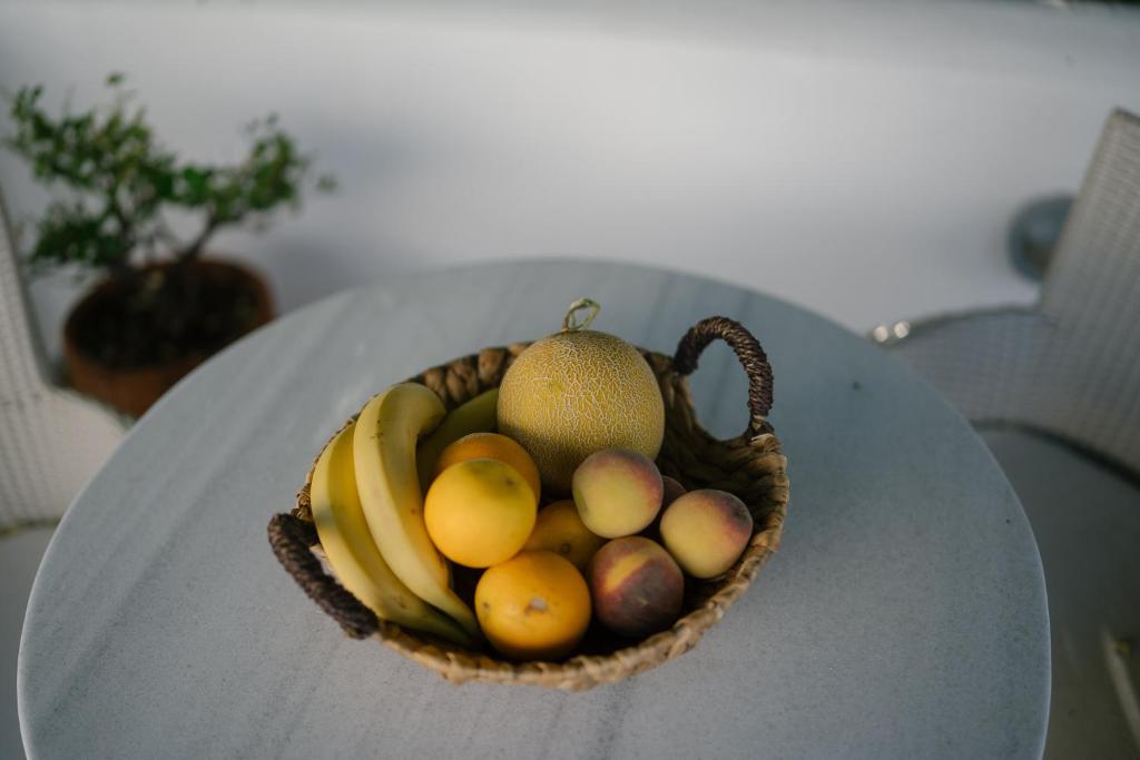 a basket of fruit sitting on a table at Indigo Studios in Livadi