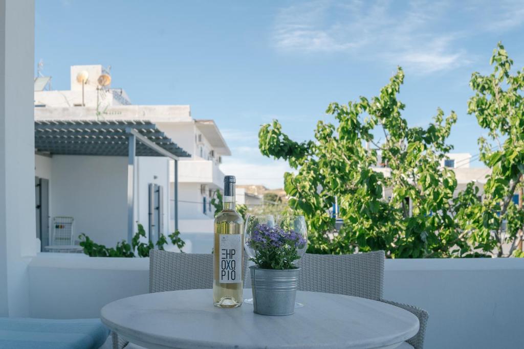 a bottle of wine sitting on top of a table at Indigo Studios in Livadi