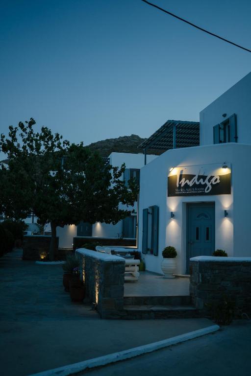 a building with a sign on the front of it at night at Indigo Studios in Livadi
