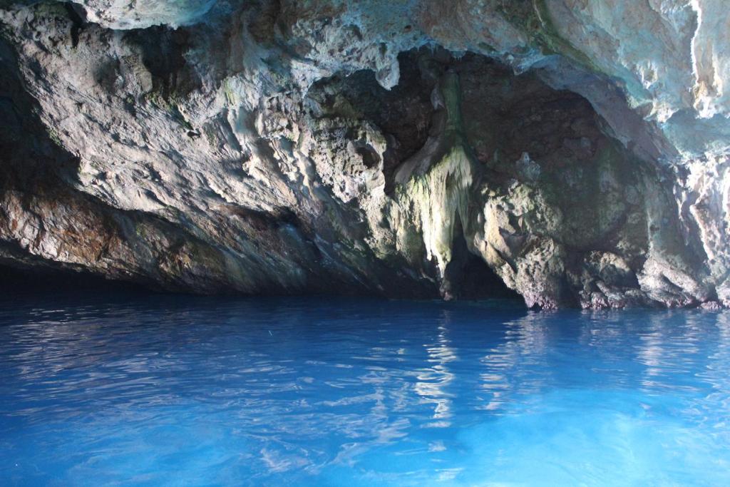 a cave with blue water inside of it at IsolaDino b&b sweet home in Praia a Mare