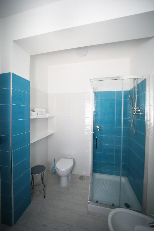 a bathroom with a toilet and a glass shower at IsolaDino b&b sweet home in Praia a Mare