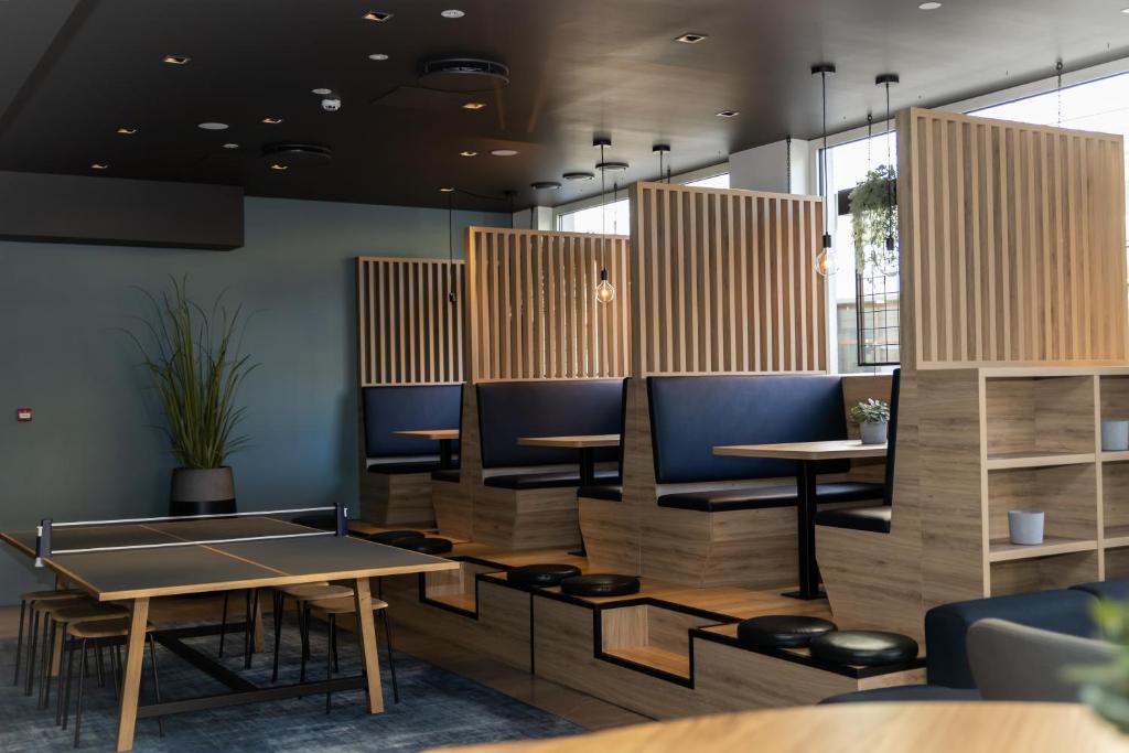 a dining room with tables and blue chairs at Comfort Hotel Børsparken in Oslo