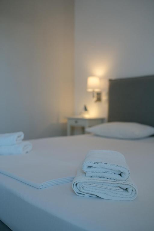 a pair of towels on a bed in a room at Indigo Studios in Livadi
