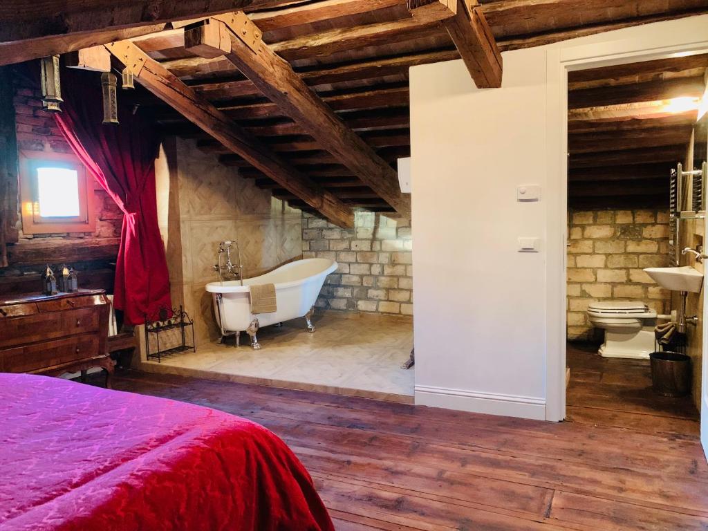 a bedroom with a bed and a tub and a sink at Ca Dode Grand Canal in Venice
