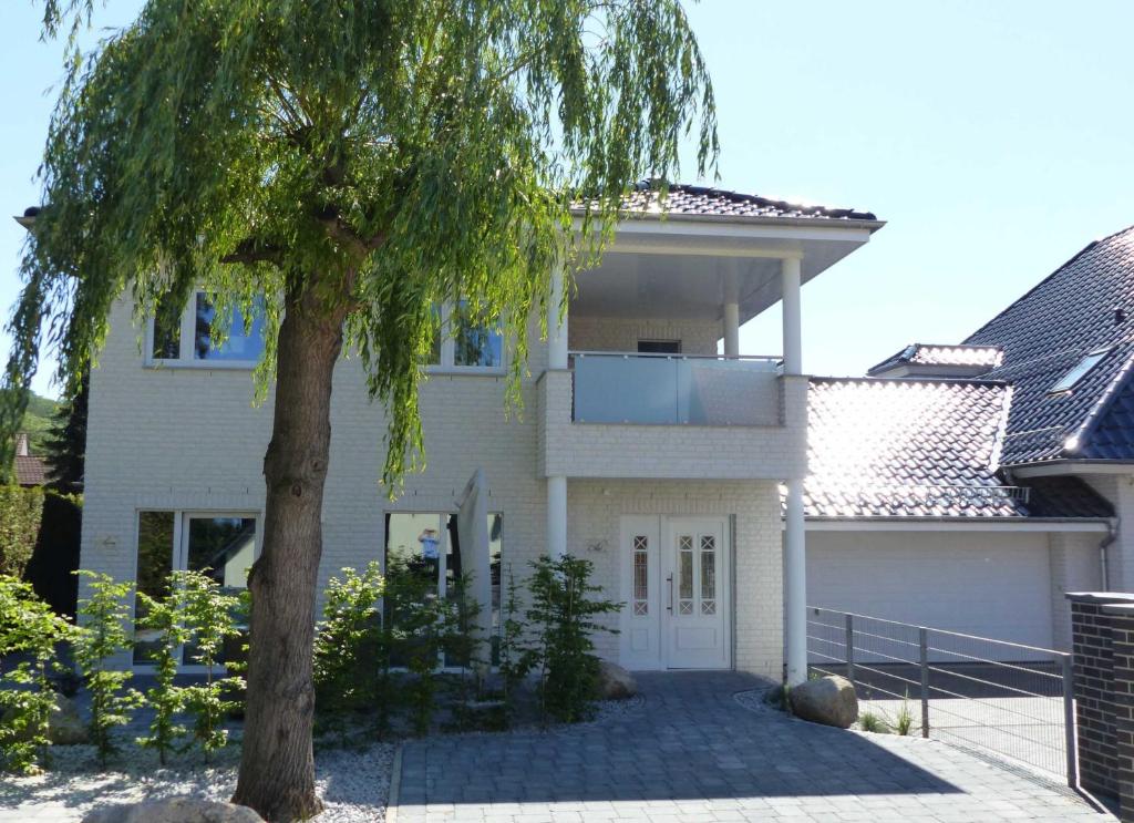a house with a tree in front of it at 3-Raum-Appartements in der Rabenstraße in Binz