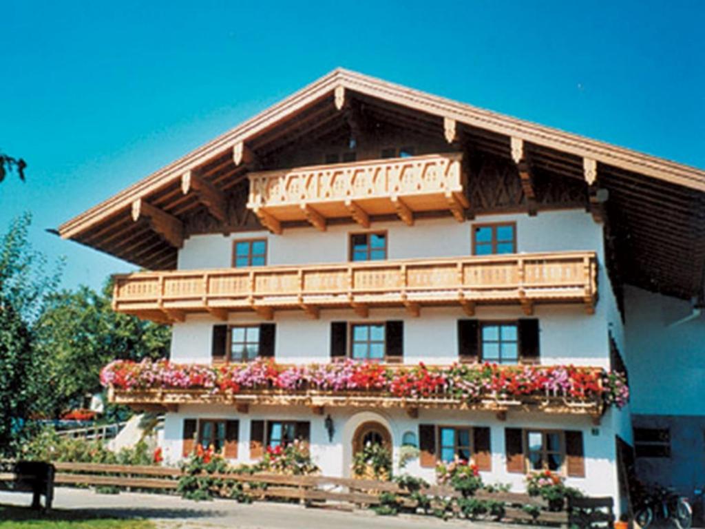 a large building with flowers in front of it at König Andrea Schwaigerhof Rottau in Rottau