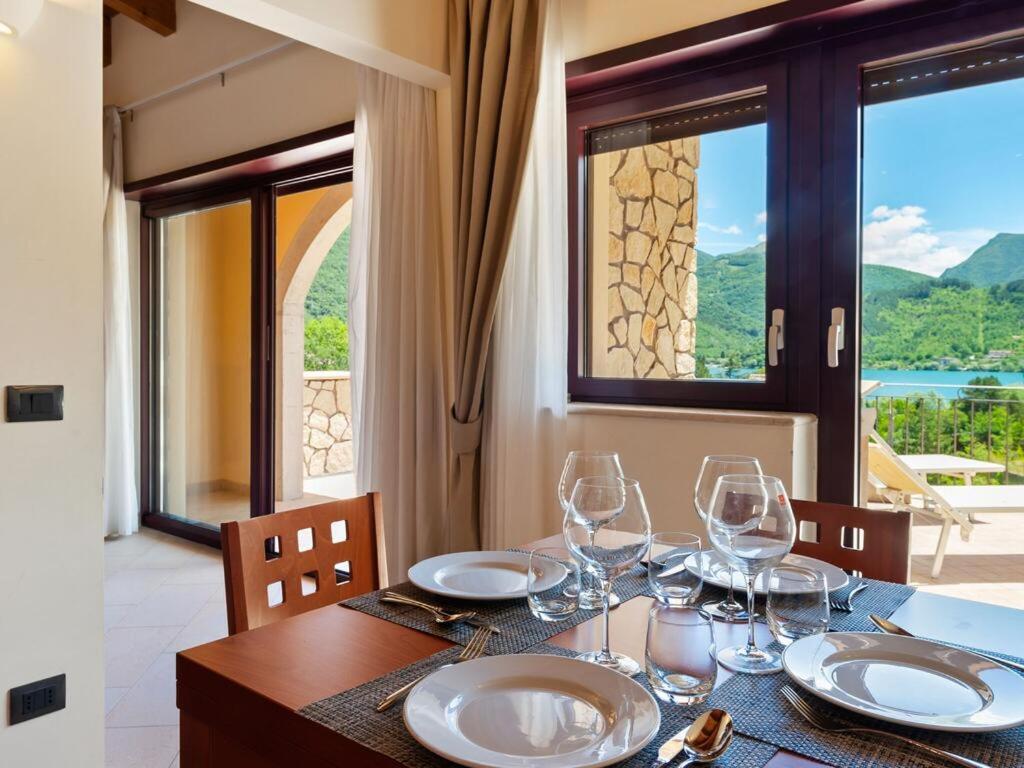 a table with wine glasses on it with a view at Tassido Coda Resort in Scanno