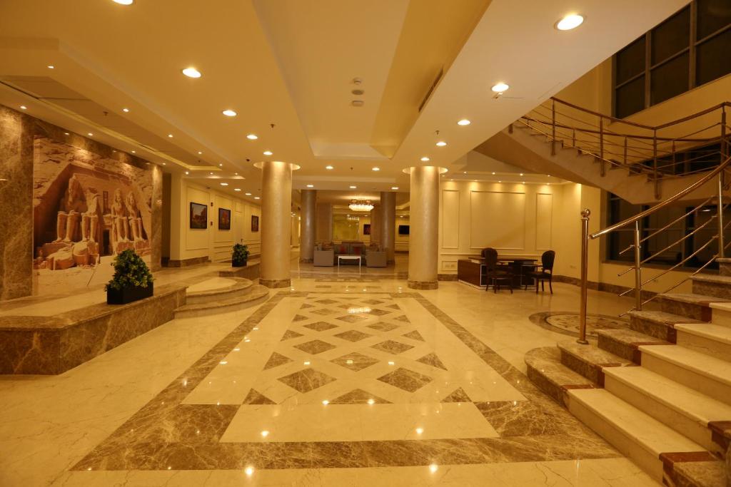 a lobby of a building with stairs and a stair case at Citymax aqua park Hotel Aswan in Aswan