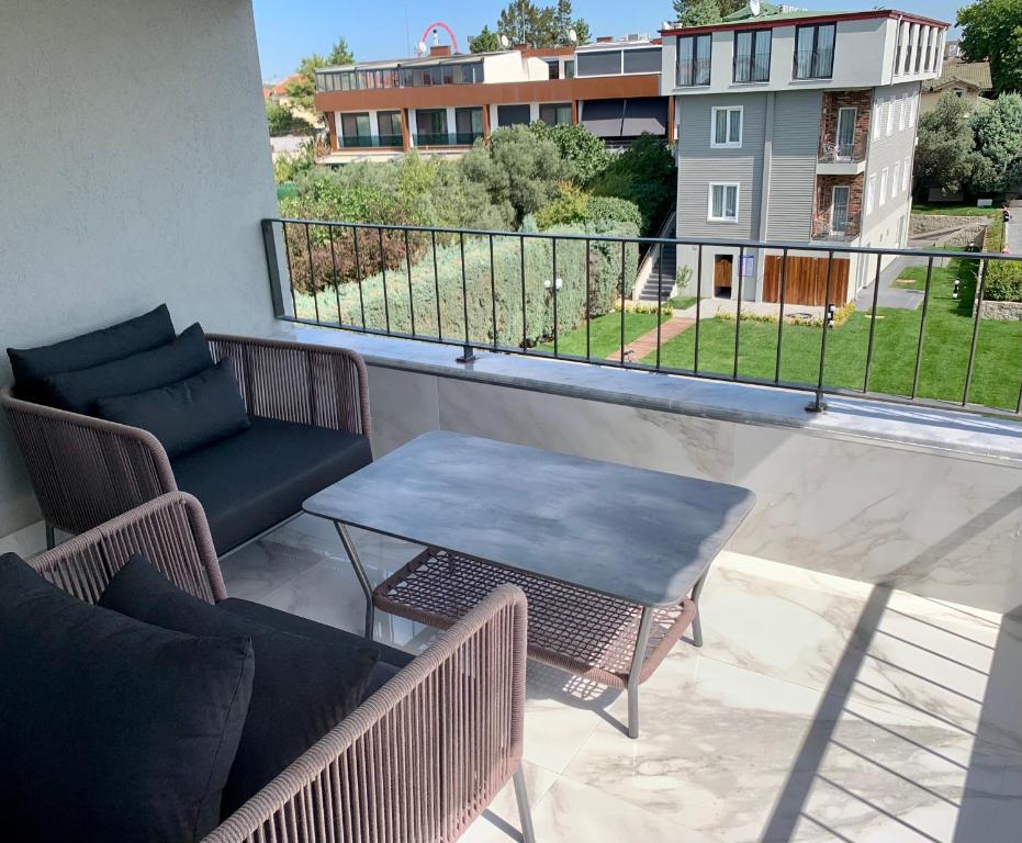 a balcony with a table and chairs and a view at Istanbul Park Hotel in Tuzla