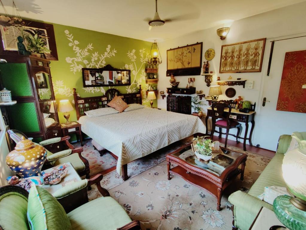 a bedroom with a bed and a living room at On The House in New Delhi
